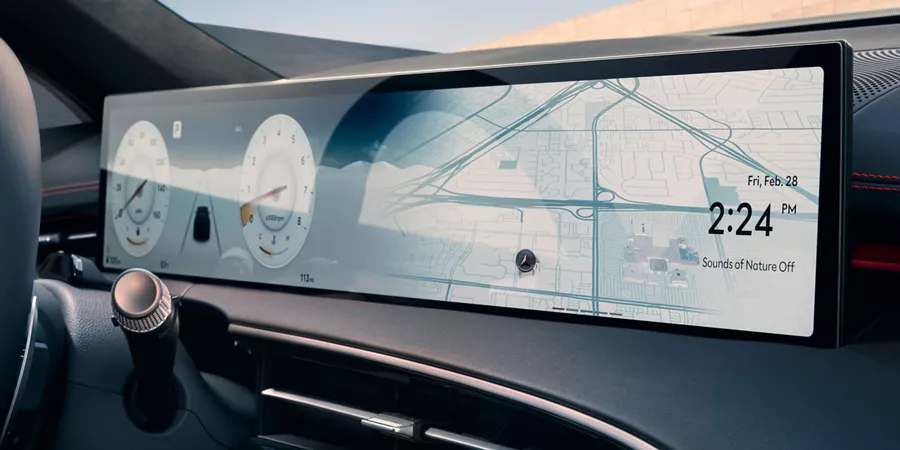 Interior close up of Genesis GV70 infotainment screen displaying odometer and navigation