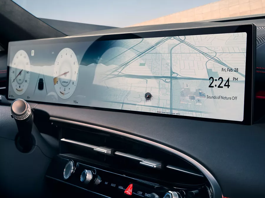 Interior close up of Genesis GV70 infotainment screen displaying odometer and navigation