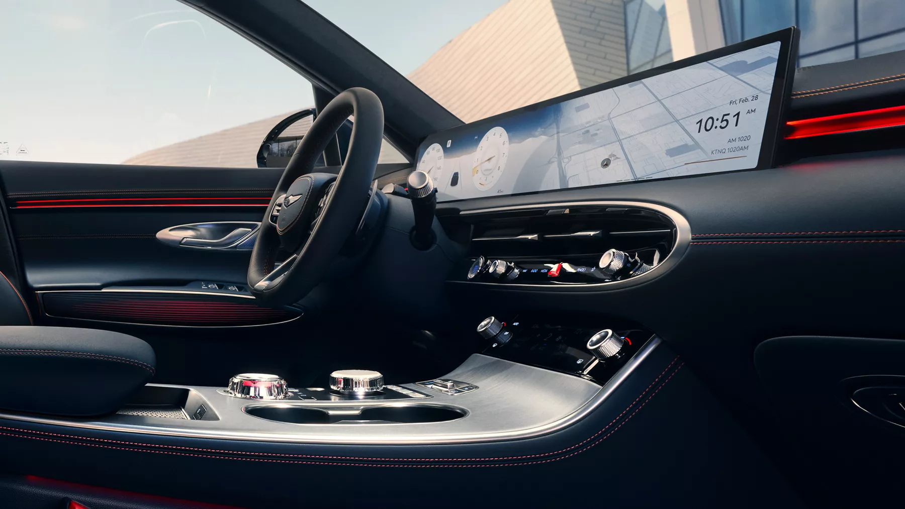 Interior close-up of cockpit, steering wheel and OLED display, from passenger seat of Genesis GV70