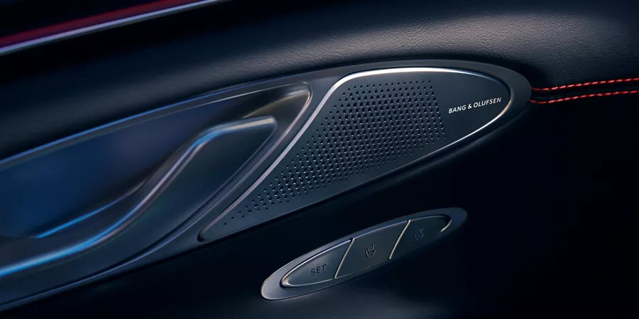 Interior close-up of Bang & Olufsen speaker on driver side door panel inside Genesis GV70