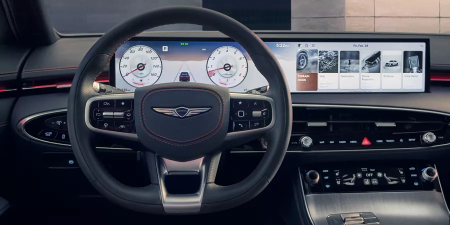 Interior close-up of 27" OLED infotainment display, steering wheel and dashboard inside Genesis GV70