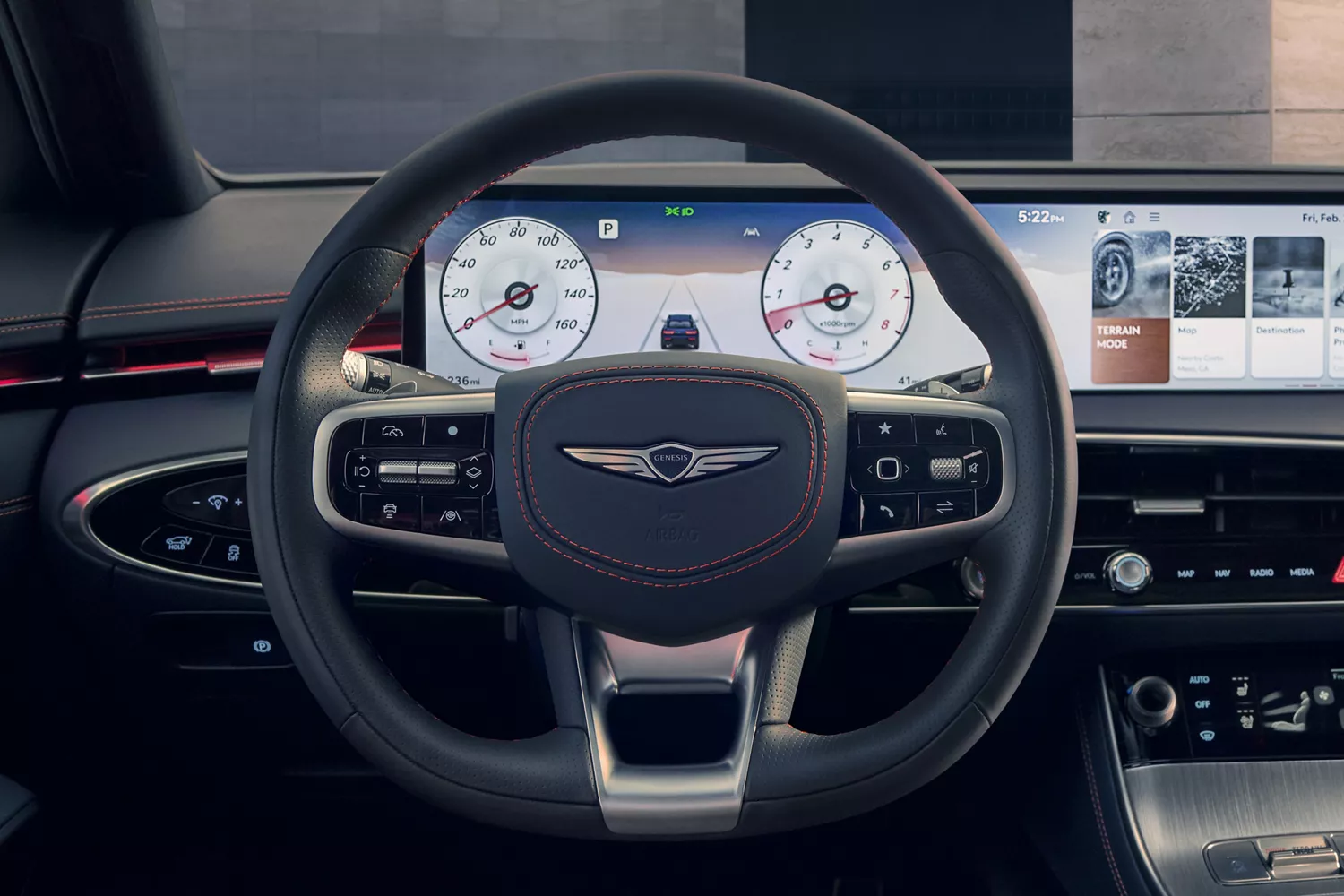 Interior close-up of 27" OLED infotainment display, steering wheel and dashboard inside Genesis GV70