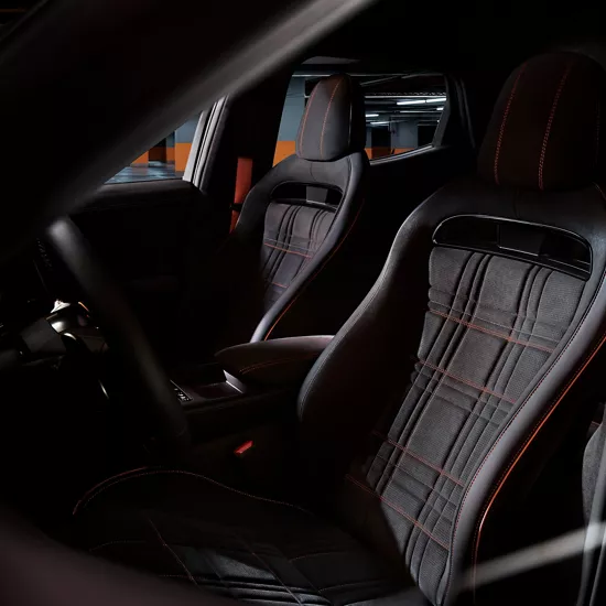 Interior view from front driver side window of cockpit and seating in Genesis GV60 Magma