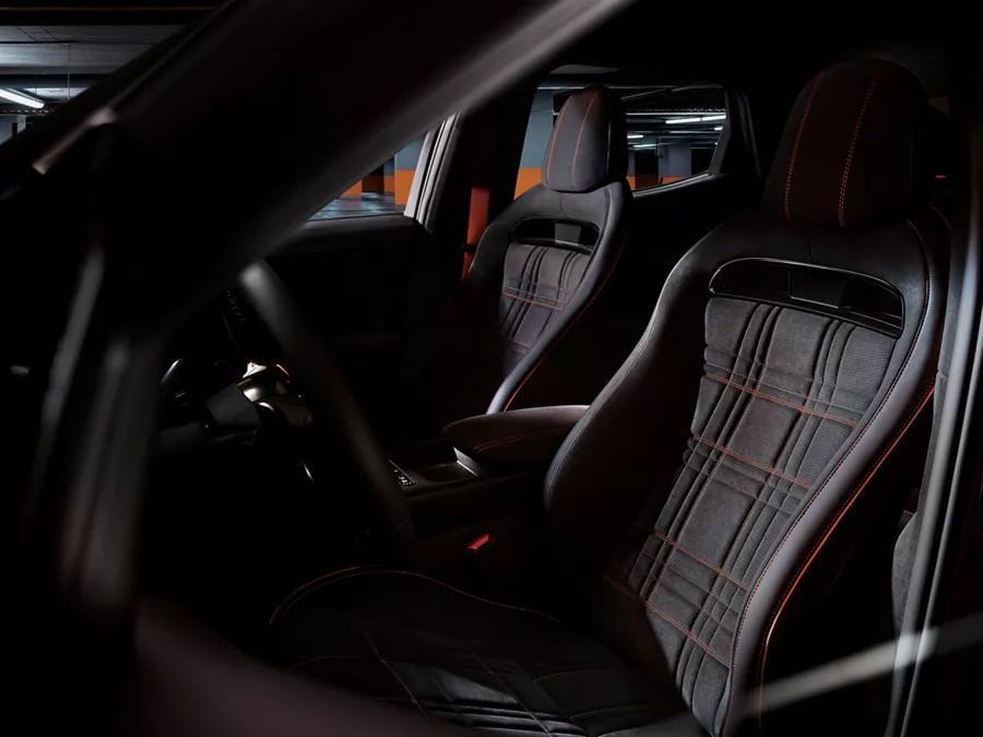 Interior view from opened driver side door of 2027 Genesis GV60 Magma cockpit