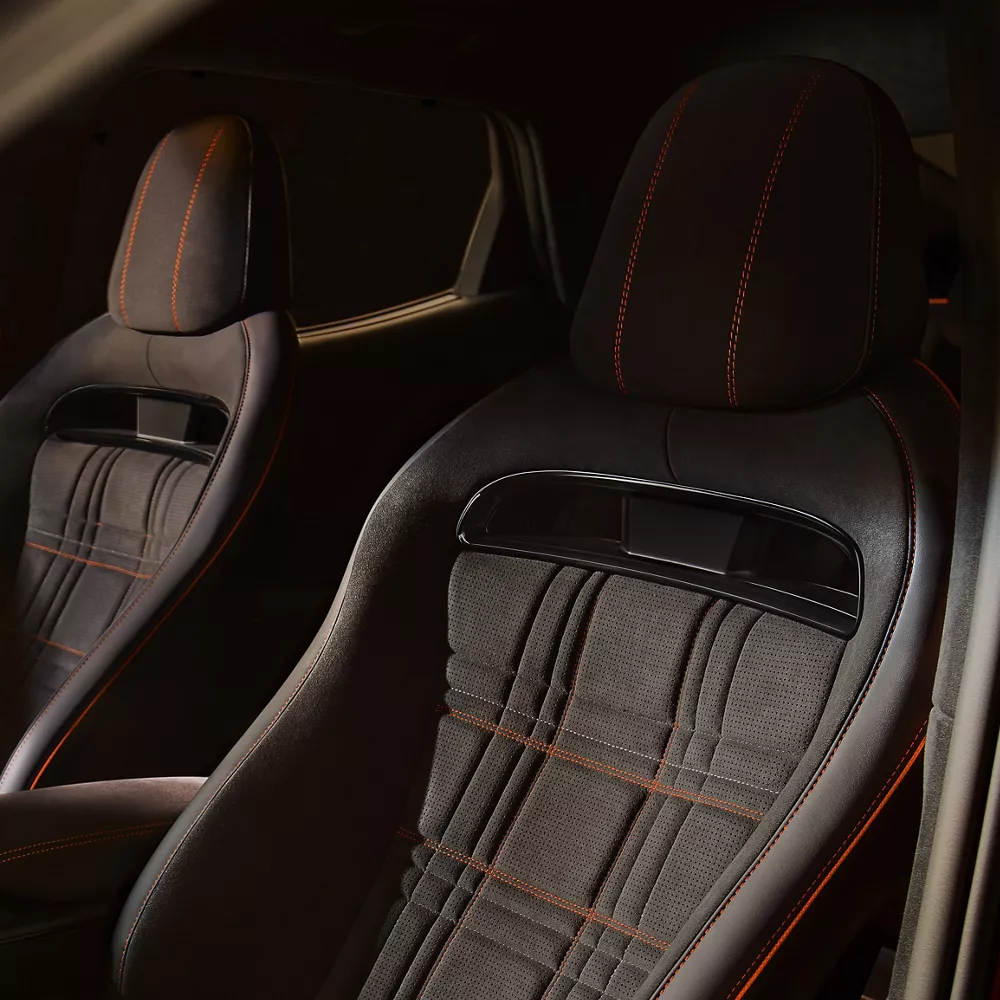 Interior close up from driver side window of 2027 Genesis GV60 Magma seating details