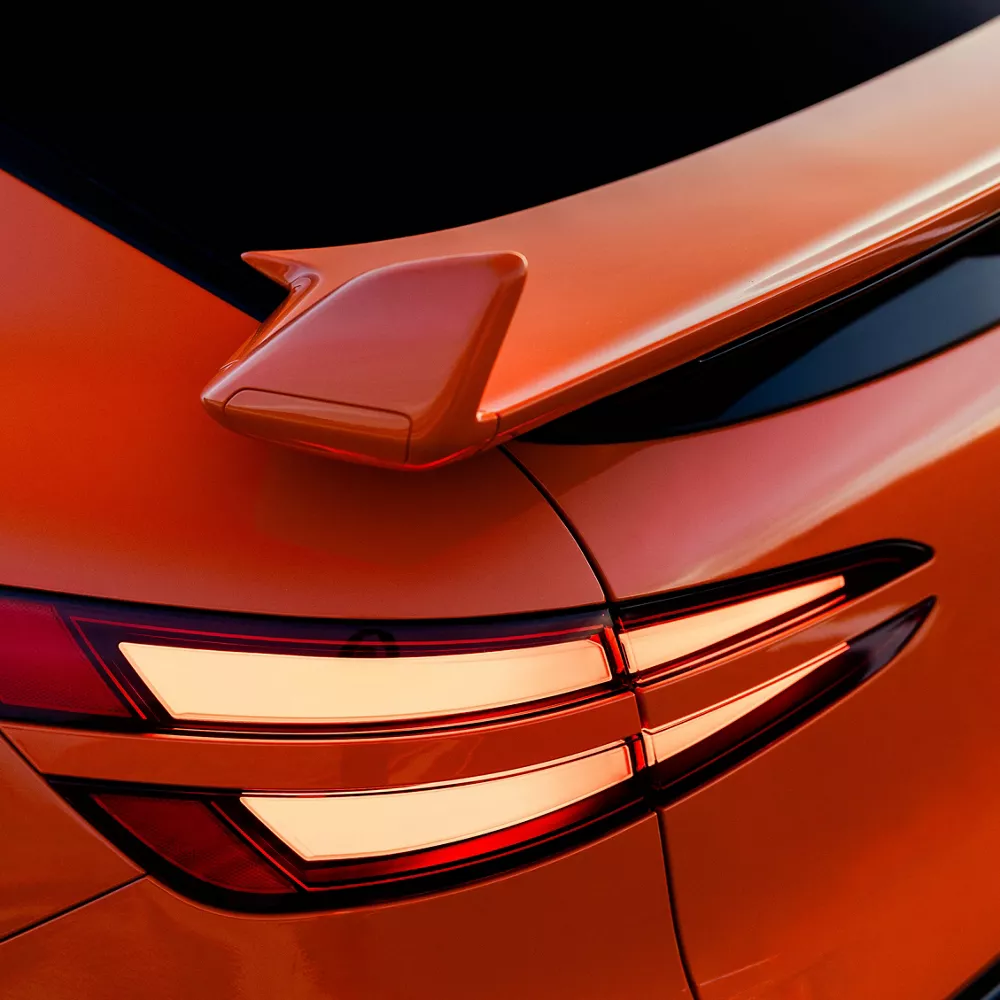 3/4 rear driver side close up of spoiler and taillight on 2027 Genesis GV60 Magma in orange