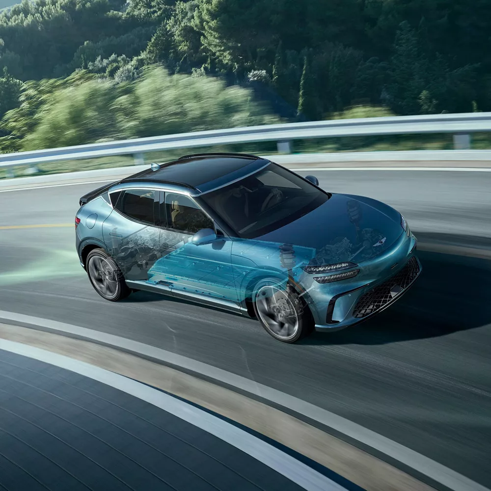Genesis GV60 on mountain road, with computer generated cross section of suspension system