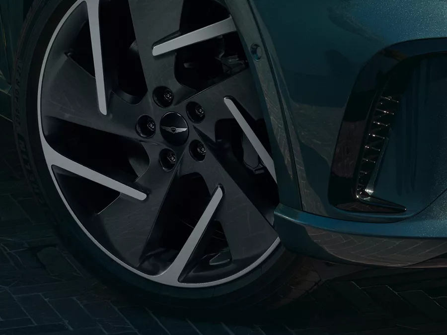 Close up of front passenger side wheel details on Genesis GV60 in Tromso Green