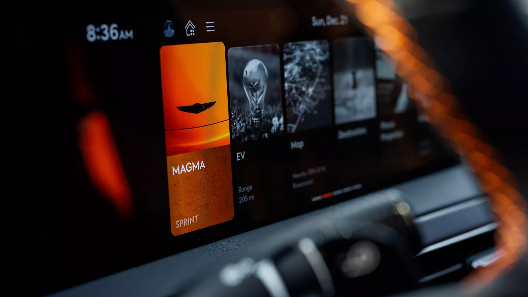 Closeup from steering wheel pov of Sprint Mode selected on dashboard in 2027 Genesis GV60 Magma