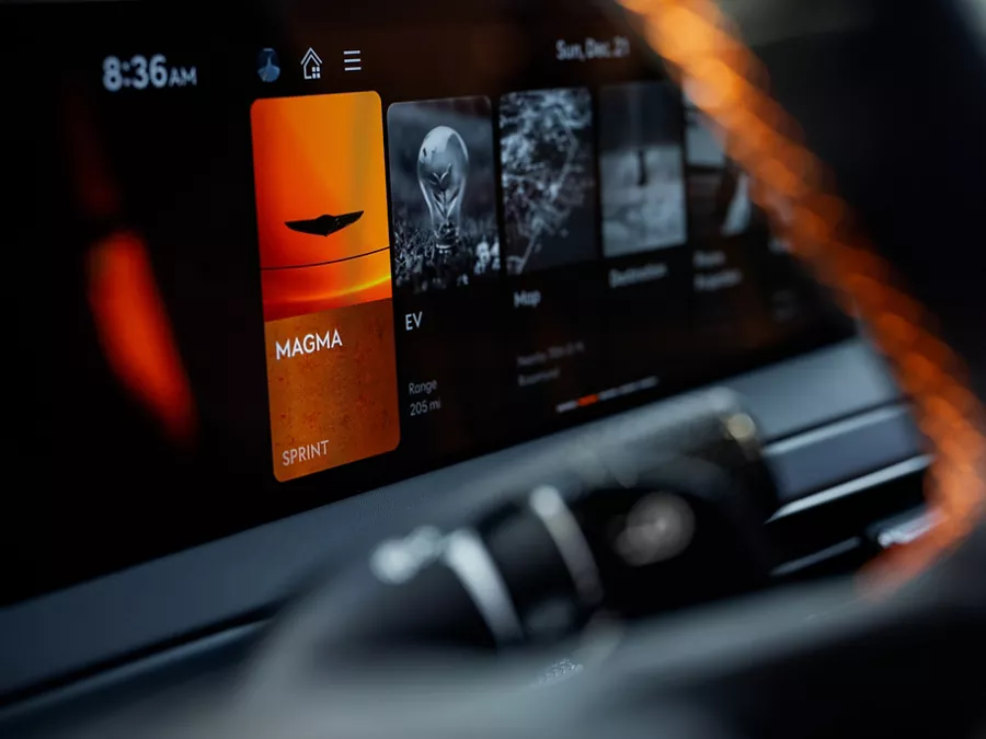 Closeup from steering wheel pov of Sprint Mode selected on dashboard in 2027 Genesis GV60 Magma