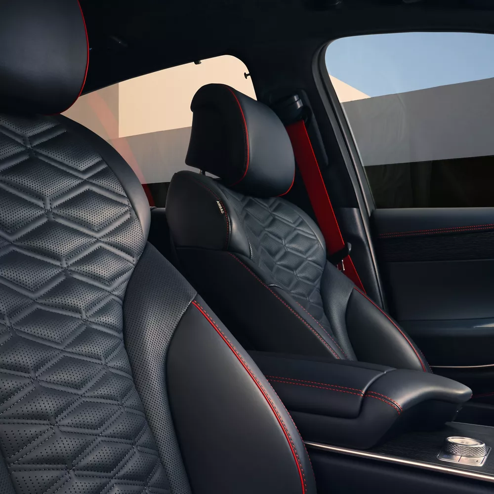 Interior close up of Genesis GV80 Coupe Nappa leather seating in Ultramarine Blue & Orange Stitching