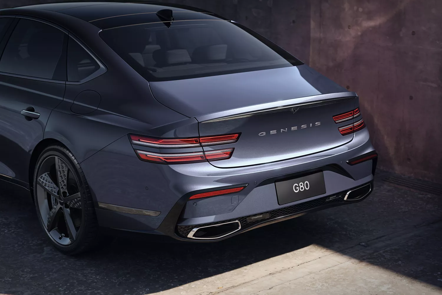 3/4 rear driver side view of exterior, taillight and trunk detail on Genesis G80 in Ceres Blue