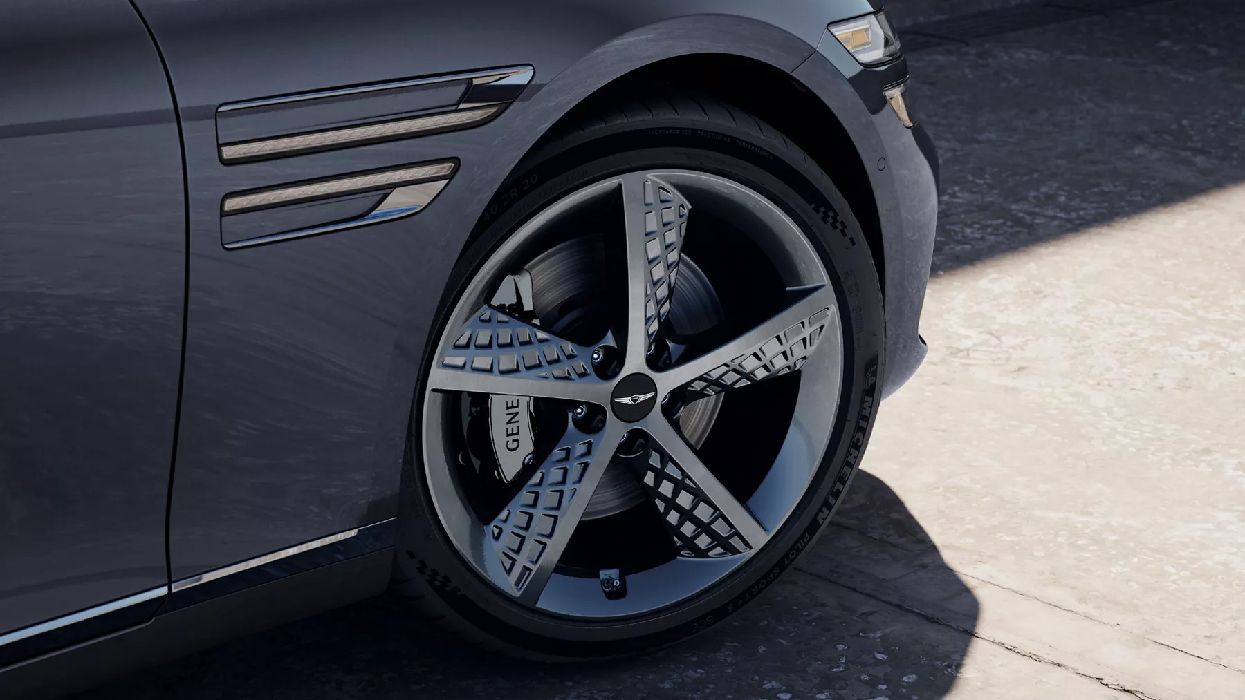 Genesis G80 in Ceres Blue with sculpted alloy wheel and front fender detail