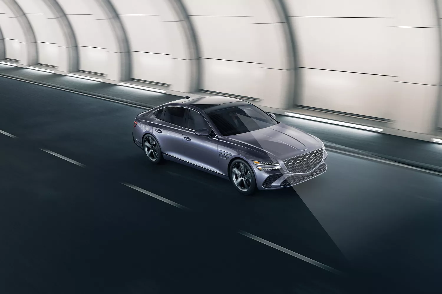 3/4 front passenger view of Genesis G80 driving through tunnel, light beam illustrating Road Preview