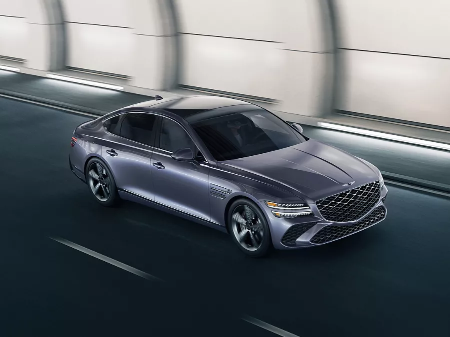 High 3/4 front passenger side view of Genesis G80 in Ceres Blue driving through tunnel
