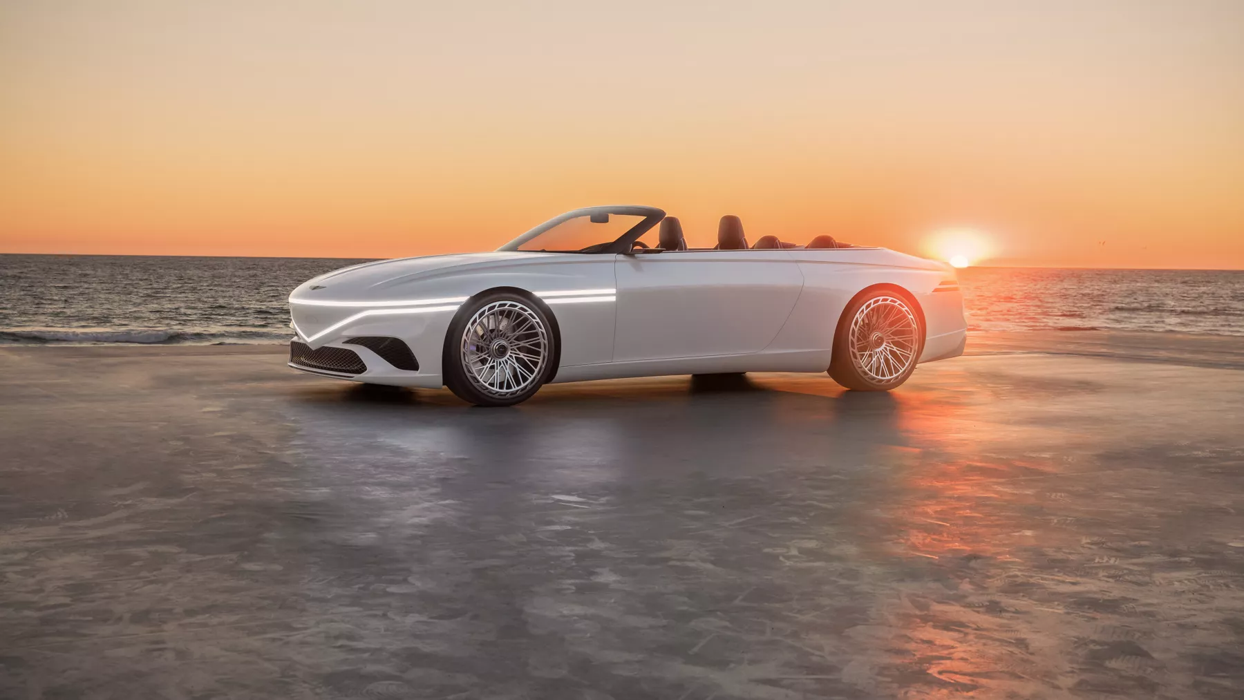 X Convertible Concept in front of a dramatic ocean sunset. 