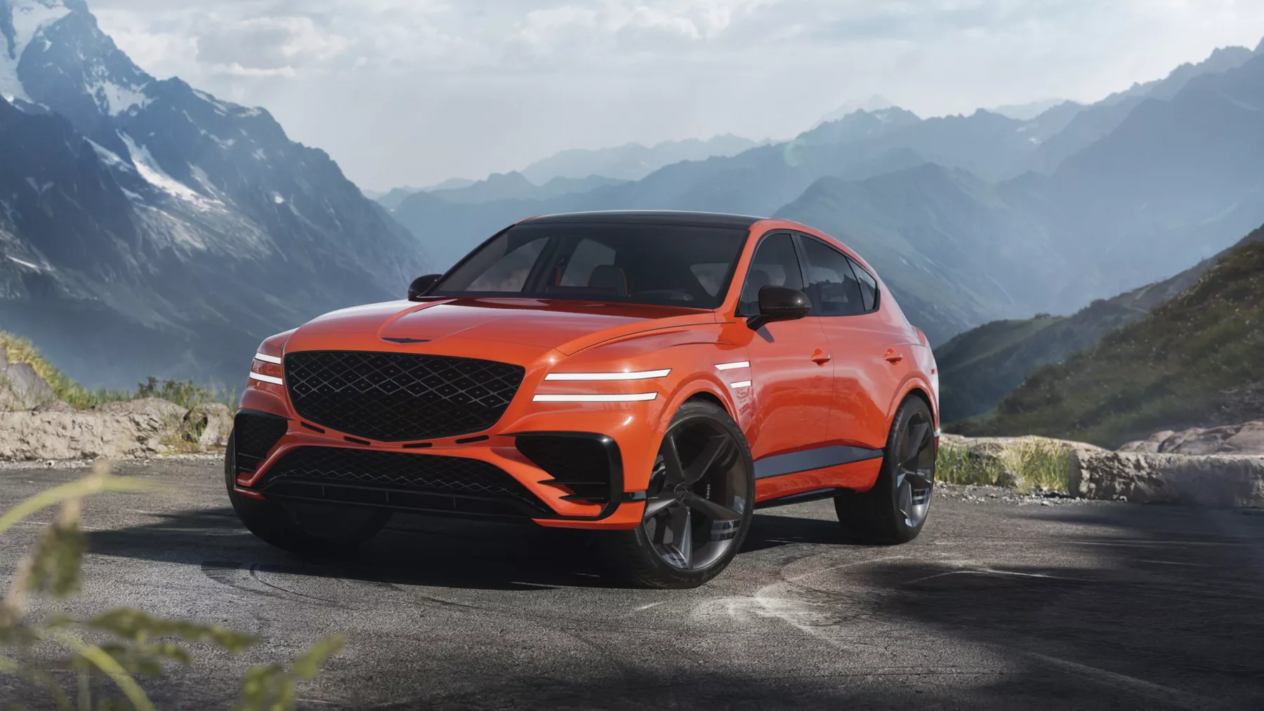 GV80 Coupe Concept is dramatically positioned against a mountain landscape.