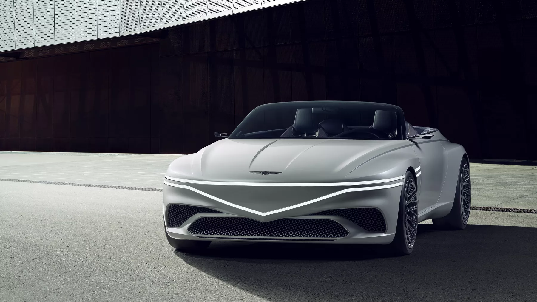 Front view of parked X Convertible Concept with headlights illuminated.
