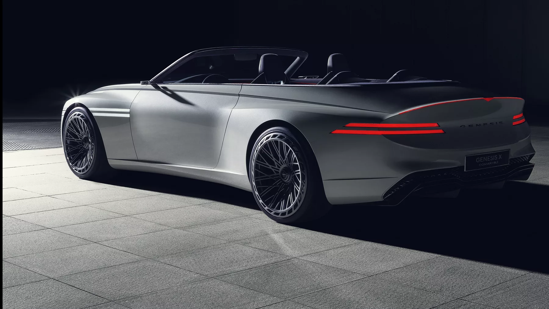 Rear view of X Convertible Concept at night with taillights illuminated.