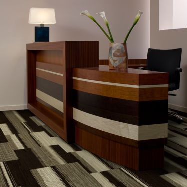 Interface Across the Board carpet tile in reception area with wood desk and Calla lillies image number 1