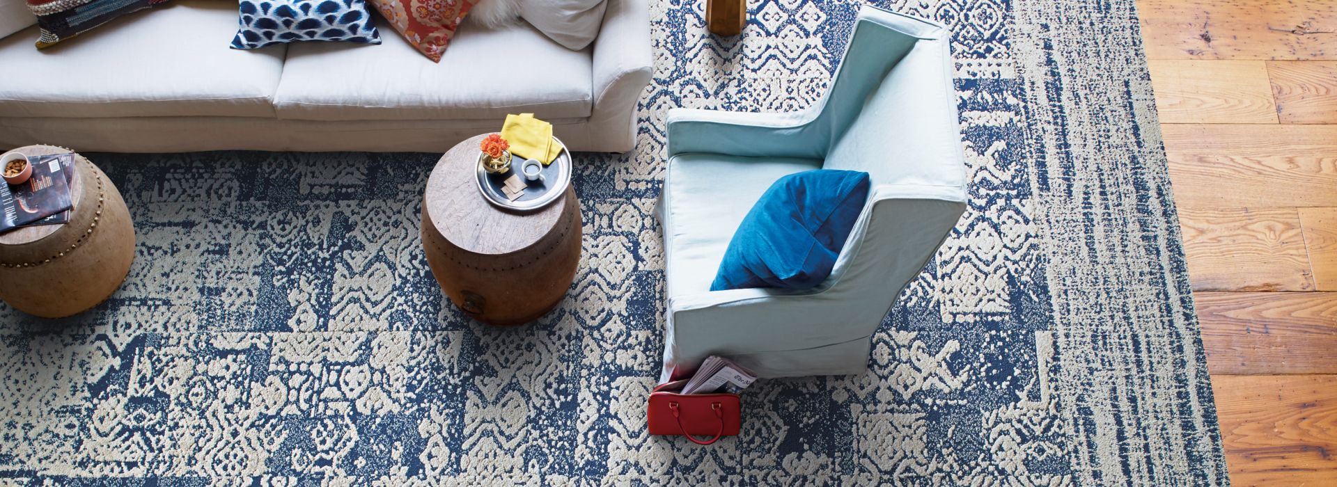 Interface PM01, PM39, and PM49 plank carpet tile in overhead view of living room area with light colored furniture