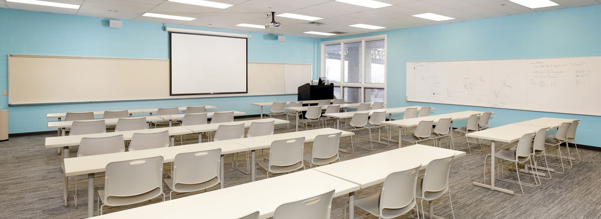 Interface Grooved carpet tile in training room with rows of white tables and chairs image number 1