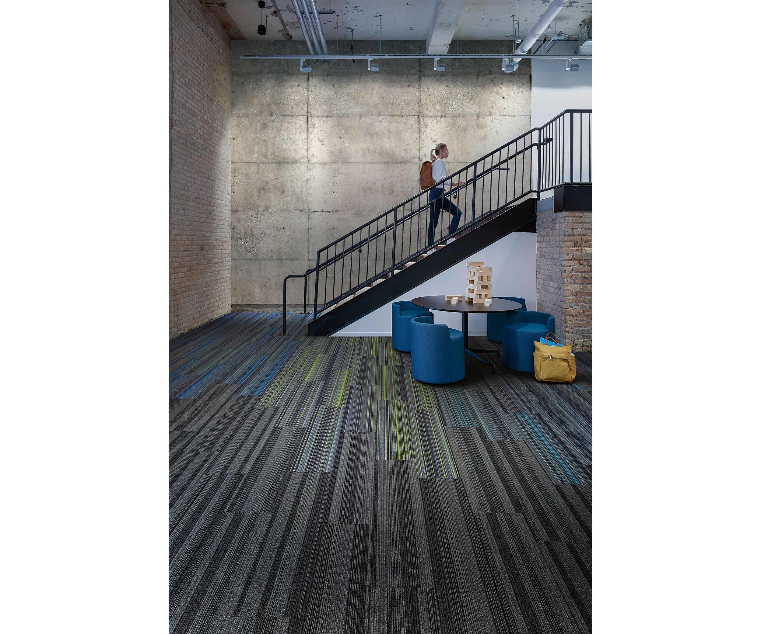 Interface Translucent and Aglow plank carpet tile in open area with man climbing stairs image number 2