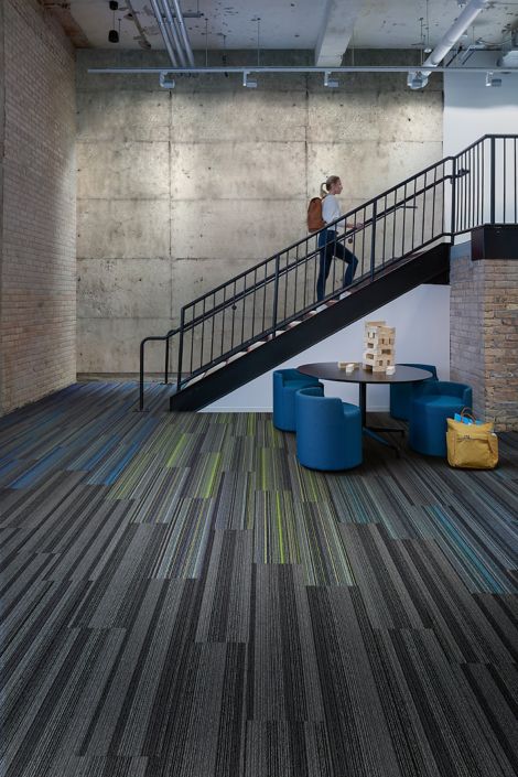 Interface Translucent and Aglow plank carpet tile in open area with man climbing stairs image number 2