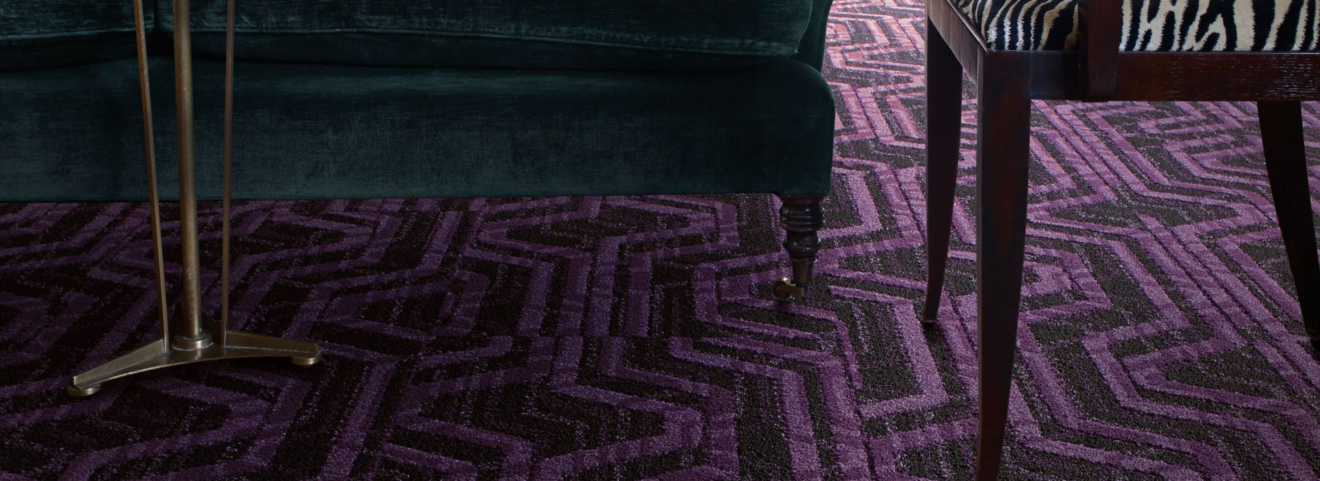 Interface PM19 plank carpet tile in living room area with green sofa zebra colored chair