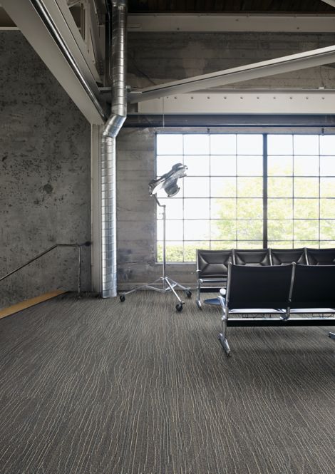 Interface Snow Moon plank carpet tile in waiting area with concrete walls and exposed beams image number 2