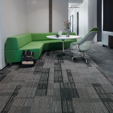 Interface Summerhouse Shades carpet tile and Natural Stones LVT in seating area with green couch imagen número 1