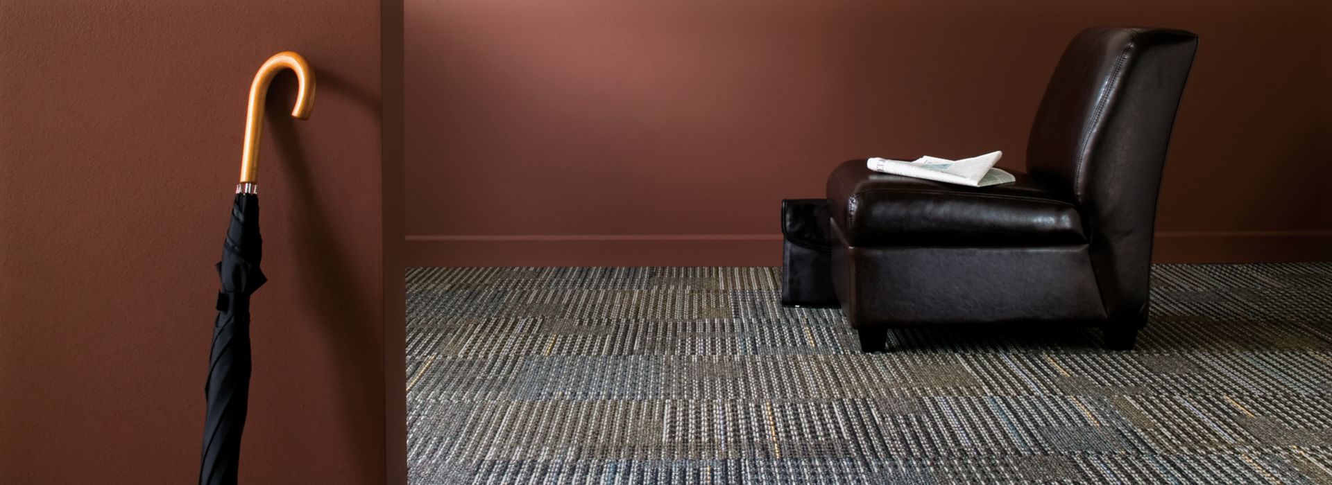 Interface Cotswold II carpet tile with black chair and umbrella