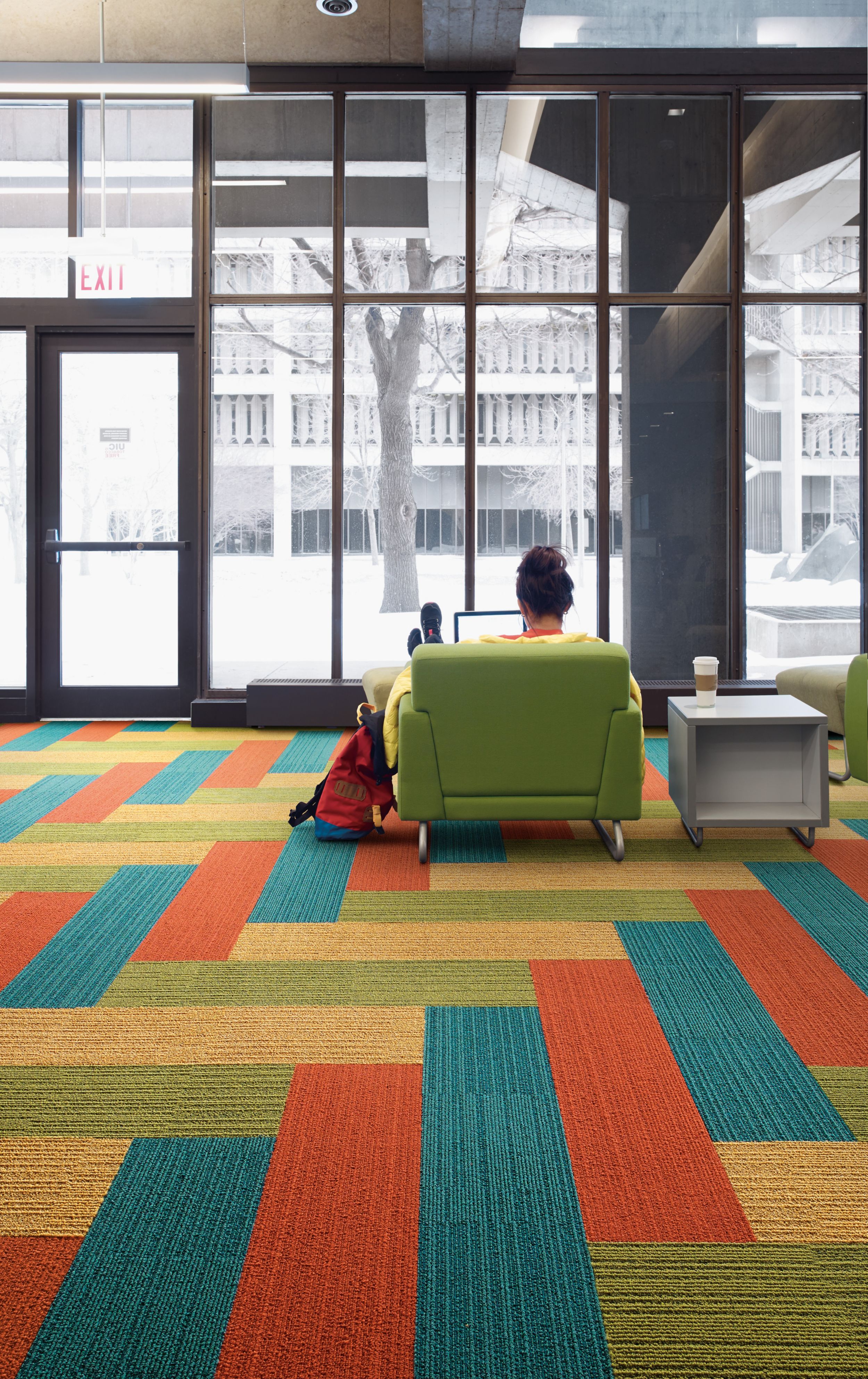 Interface On Line plank carpet tile with woman sitting in green chair studying and snow outside windows image number 3