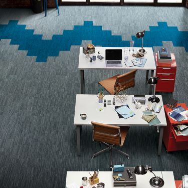 Aerial view of Interface B702 plank carpet tile in open office with red filing cabinets