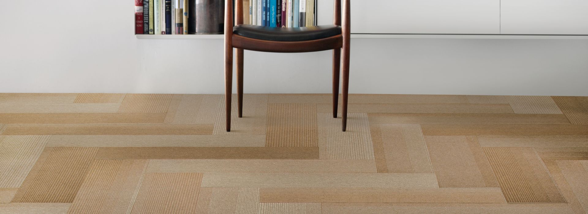 Interface B701 plank carpet tile in front of bookcase with wood chair image number 1