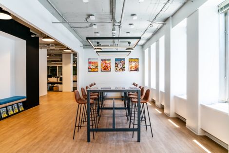 Interface Steady Stride LVT in meeting area with large windows and artwork on wall