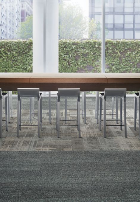 Interface AE310 carpet tile and Harmonize plank carpet tile in open work area with long table