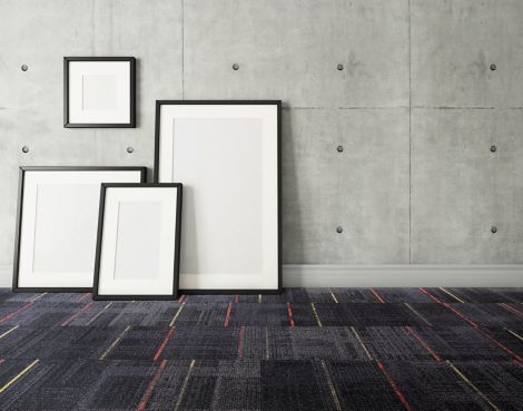 Interface AE312 carpet tile in open room with blank canvases against wall image number 7