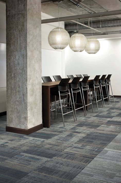 Interface AE312 carpet tile and AE311 plank carpet tile in industrial-themed office meeting area