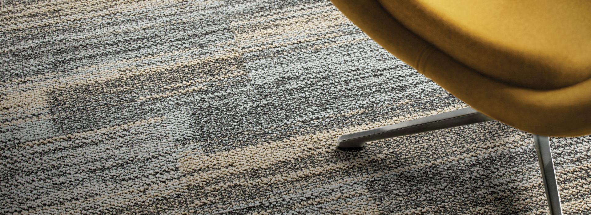 Close-up of Interface AE313 plank carpet tile with yellow chair