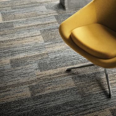 Close-up of Interface AE313 plank carpet tile with yellow chair image number 1