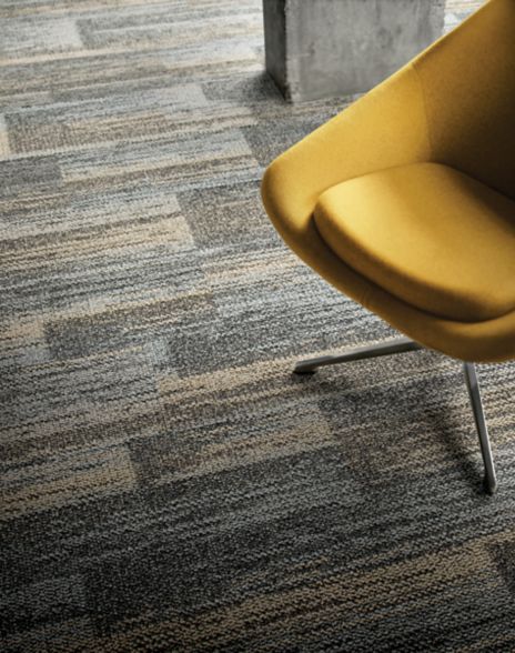 Close-up of Interface AE313 plank carpet tile with yellow chair
