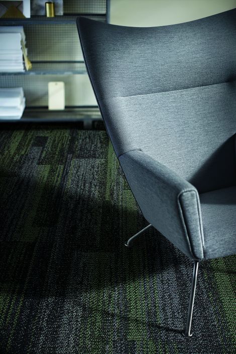Close-up of Interface AE313 plank carpet tile with grey chair