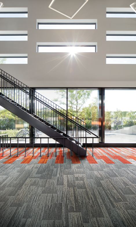 Interface Aerial Flying Colors AE311, AE315 and AE317 plank carpet tile in lobby with stairwell