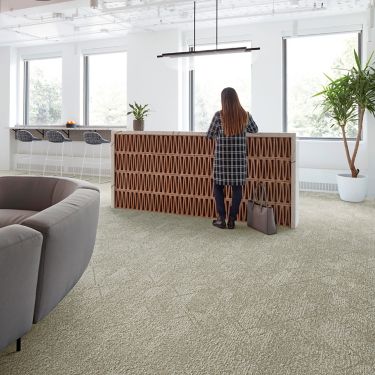 Interface Angle Up plank carpet tile in reception area with woman standing at desk image number 1