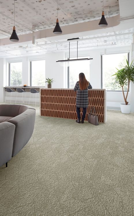 Interface Angle Up plank carpet tile in reception area with woman standing at desk