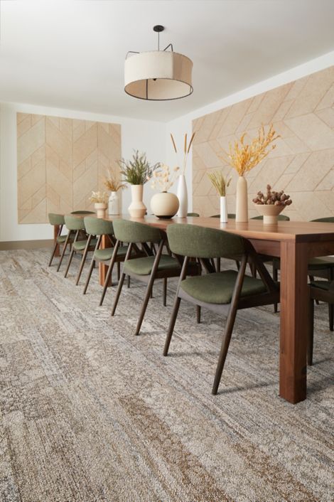 Interface Eben plank carpet tile in dining area with long wood table and upholstered chairs