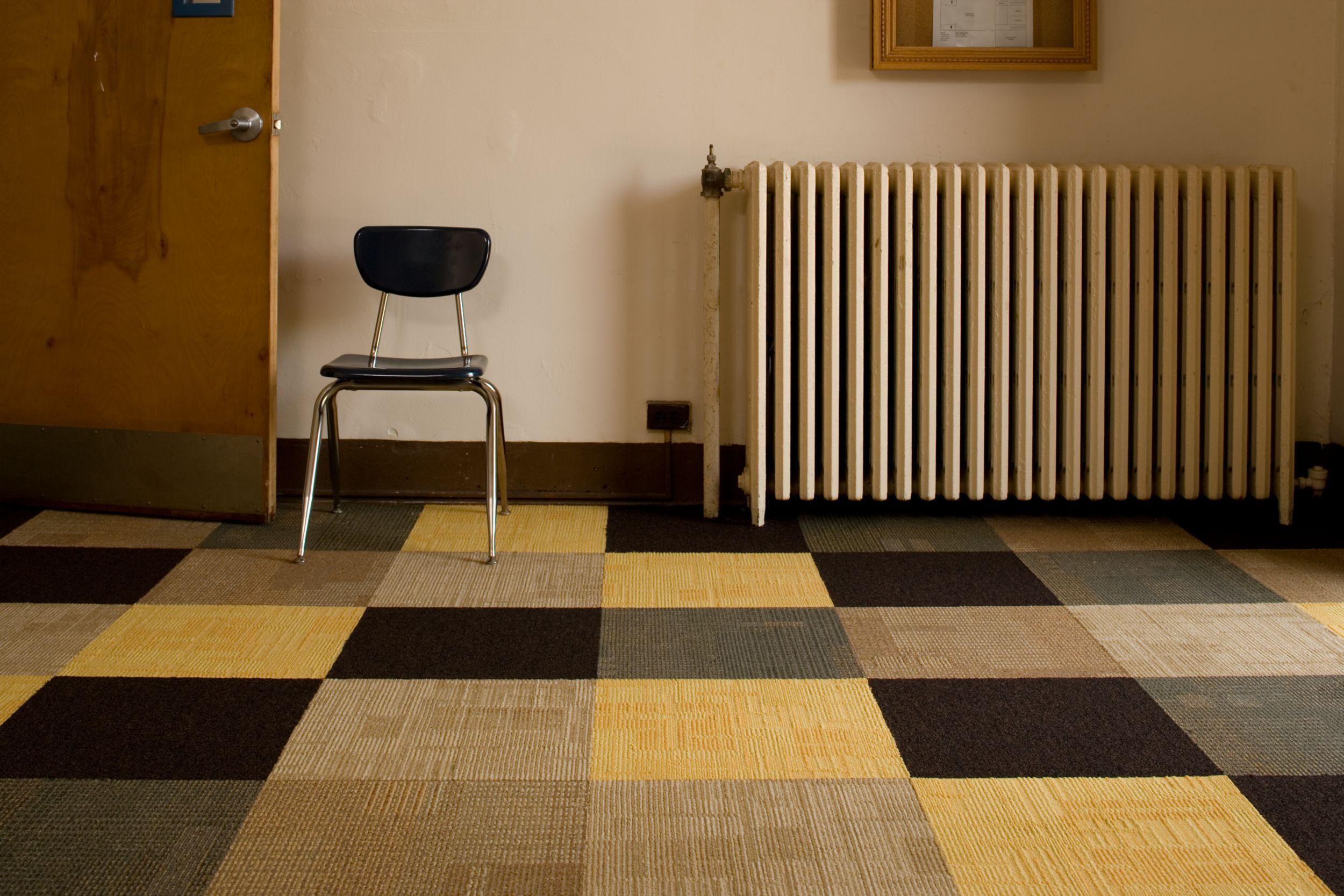 Interface Berlin, Syncopation and Menagerie II carpet tile in large room with wooden chair and radiator image number 5