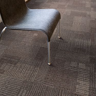 Close up of Interface Berlin carpet tile underneath chair imagen número 1