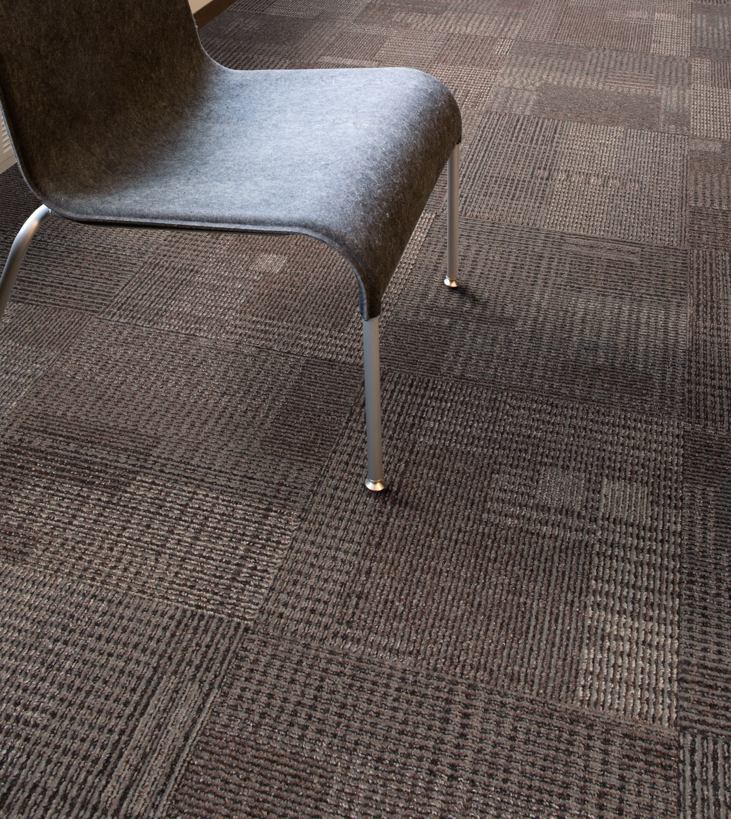 Close up of Interface Berlin carpet tile underneath chair image number 1